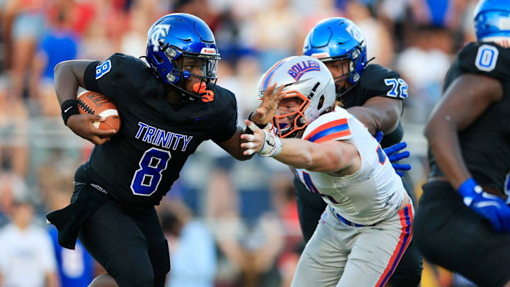 Trinity Christian's Hicks Zarah (8) is pressured by Bolles' Asher Ghioto (34) during the second quarter of a high school football matchup Friday, Aug. 30, 2024 at Trinity Christian Academy in Jacksonville, Fla. The Bolles Bulldogs defeated the Trinity Christian Conquerors 41-7.