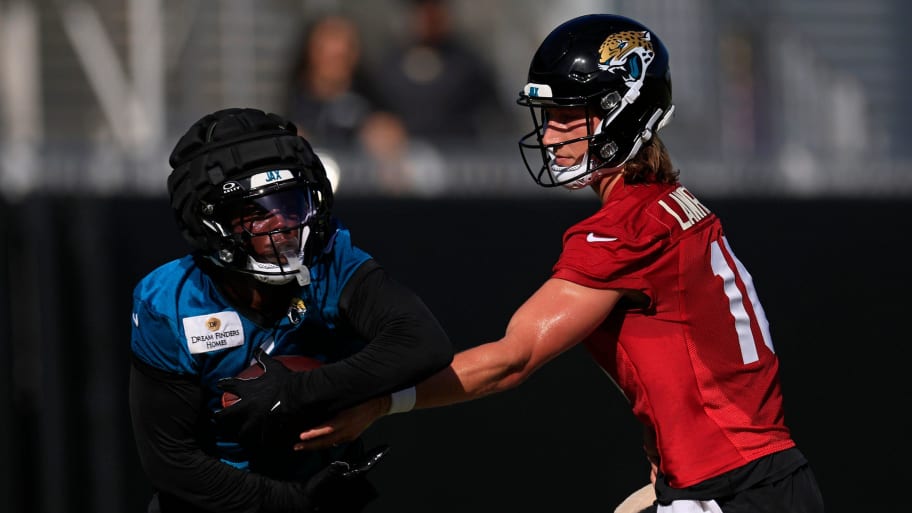 Jacksonville Jaguars quarterback Trevor Lawrence (16) hands off to running back Travis Etienne Jr. (1) during the first day of an NFL football training camp practice Wednesday, July 24, 2024 at EverBank Stadium’s Miller Electric Center in Jacksonville, Fla. | Corey Perrine/Florida Times-Union / USA