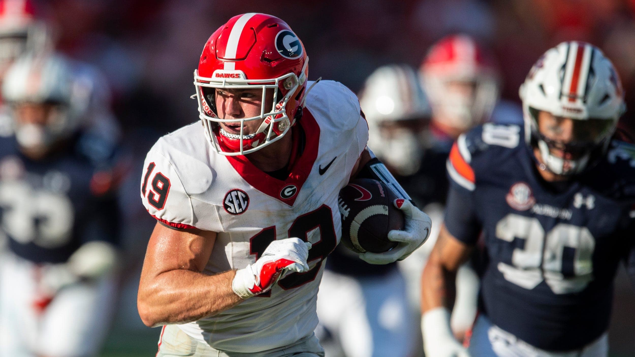 Georgia Bulldogs tight end Brock Bowers runs after a catch during the third quarter as Auburn defenders pursue him.