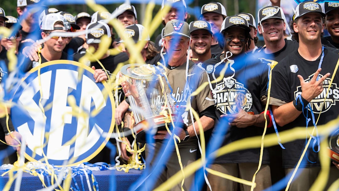 Vanderbilt Commodores head coach Tim Corbin and his team celebrate with the championship trophy as Ole Miss Rebels take on Vanderbilt Commodores during the SEC baseball tournament championship game at Hoover Met in Birmingham, Ala., on Sunday, May 25, 2025. Vanderbilt Commodores defeated Ole Miss Rebels 3-2.