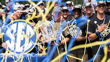 Vanderbilt Commodores head coach Tim Corbin and his team celebrate with the championship trophy as Ole Miss Rebels take on Vanderbilt Commodores during the SEC baseball tournament championship game at Hoover Met in Birmingham, Ala., on Sunday, May 25, 2025. Vanderbilt Commodores defeated Ole Miss Rebels 3-2.
