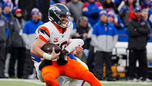 Denver Broncos quarterback Bo Nix (10) gets sacked by Buffalo Bills defensive end Greg Rousseau (50) during the second half o