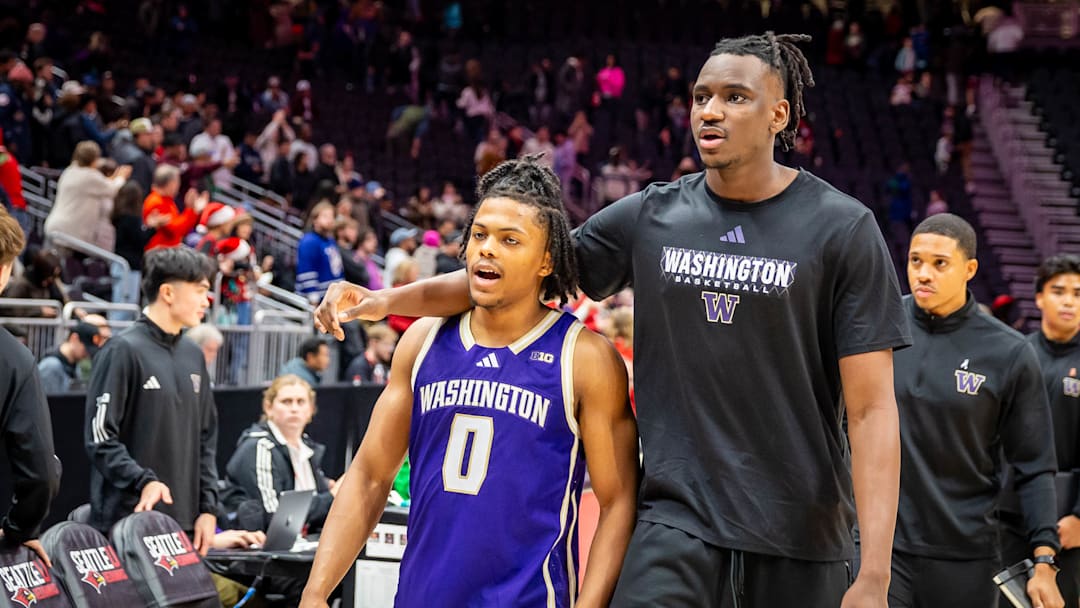 An  injured Mady Traore leaves the floor with Quimari Peterson after the Seattle U loss. 