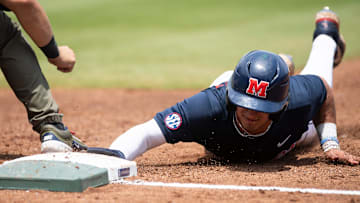 Ole Miss Rebels' Hayden Federico (9) slides safely back into first base as Ole Miss Rebels take on Vanderbilt Commodores during the SEC baseball tournament championship game at Hoover Met in Birmingham, Ala., on Sunday, May 25, 2025.