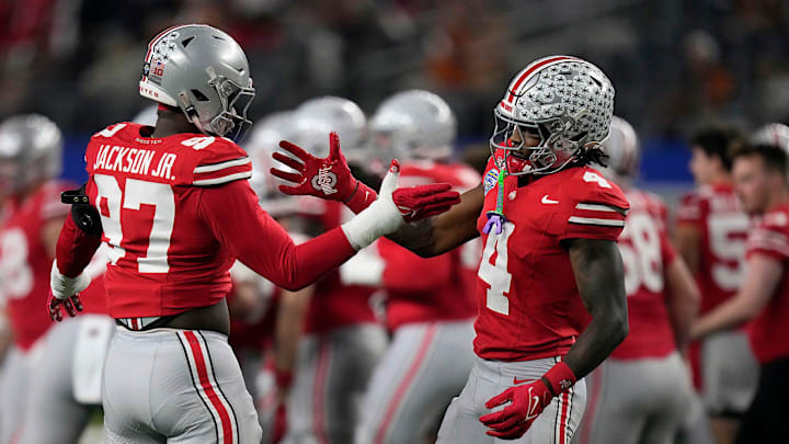 Ohio State Buckeyes defensive end Kenyatta Jackson Jr. (97) and Ohio State Buckeyes wide receiver Jeremiah Smith (4) do a hand shake during final warm ups at the Cotton Bowl Classic before their game against Texas Longhorns in the College Football Playoff semifinal game at AT&T Stadium in Arlington, Texas on January, 10, 2025.