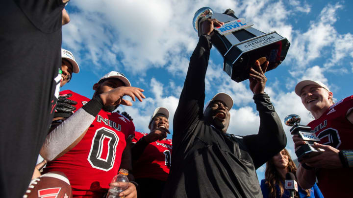 Northern Illinois Huskies head coach Thomas Hammock hoists the Camellia Bowl trophy as Arkansas State Red Wolves take on the Northern Illinois Huskies during the Camellia Bowl at Cramton Bowl in Montgomery, Ala., on Saturday, Dec. 23, 2023. Northern Illinois Huskies defeated Arkansas State Red Wolves 21-19.