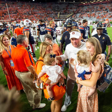 Auburn Tigers head coach Hugh Freeze greets his family after getting the program the 800th win in its history.