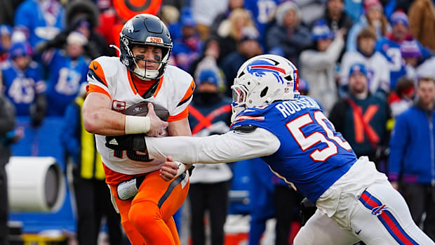 Denver Broncos quarterback Bo Nix (10) gets grabbed by and then sacked by Buffalo Bills defensive end Greg Rousseau (50) duri Denver Broncos quarterback Bo Nix (10) gets grabbed by and then sacked by Buffalo Bills defensive end Greg Rousseau (50) duri