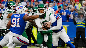 New York Jets quarterback Aaron Rodgers (8) gets sacked by Buffalo Bills defensive tackle Ed Oliver (91) and Buffalo Bills linebacker Von Miller (40) during second half action at the Bills home game against the New York Jets at Highmark Stadium in Orchard Park on Dec. 29, 2024.