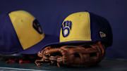 Jul 28, 2023; Atlanta, Georgia, USA; A detailed view of a Milwaukee Brewers hat and glove on the bench against the Atlanta Braves in the second inning at Truist Park. Mandatory Credit: Brett Davis-Imagn Images