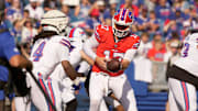Buffalo Bills quarterback Josh Allen hands the ball off to running back James Cook during the NFL training camp practice
