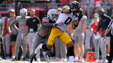 Oct 5, 2024; Columbus, OH, USA; Iowa Hawkeyes wide receiver Jarriett Buie (0) makes a catch against Ohio State Buckeyes cornerback Denzel Burke (10) in the second quarter during the NCAA football game at Ohio Stadium.