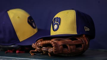 Jul 28, 2023; Atlanta, Georgia, USA; A detailed view of a Milwaukee Brewers hat and glove on the bench against the Atlanta Braves in the second inning at Truist Park. Mandatory Credit: Brett Davis-Imagn Images