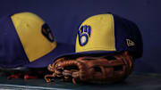 Jul 28, 2023; Atlanta, Georgia, USA; A detailed view of a Milwaukee Brewers hat and glove on the bench against the Atlanta Braves in the second inning at Truist Park. Mandatory Credit: Brett Davis-Imagn Images