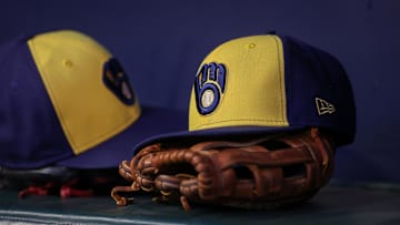 Jul 28, 2023; Atlanta, Georgia, USA; A detailed view of a Milwaukee Brewers hat and glove on the bench against the Atlanta Braves in the second inning at Truist Park. Mandatory Credit: Brett Davis-Imagn Images
