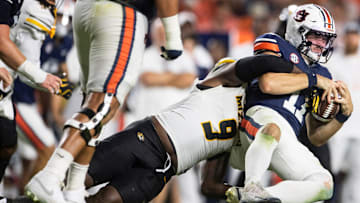 Auburn Tigers quarterback Jackson Arnold (11) is sacked by Missouri Tigers defensive end Zion Young (9) as the Auburn Tigers take on the Missouri Tigers at Jordan-Hare Stadium.