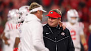 Mississippi Rebels head coach Lane Kiffin talks to Georgia Bulldogs head coach Kirby Smart before a game at Sanford Stadium in 2023. Credit: Brett Davis-Imagn Images