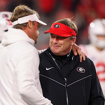 Mississippi Rebels head coach Lane Kiffin talks to Georgia Bulldogs head coach Kirby Smart before a game at Sanford Stadium in 2023. Credit: Brett Davis-Imagn Images