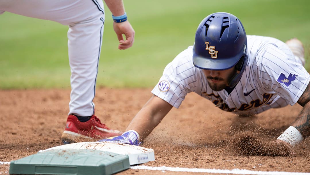LSU Tigers' Cade Arrambide (0) dives safely back into first base as Ole Miss Rebels take on LSU Tigers during the SEC baseball tournament at Hoover Met in Birmingham, Ala., on Saturday, May 24, 2025.