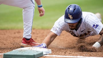 LSU Tigers' Cade Arrambide (0) dives safely back into first base as Ole Miss Rebels take on LSU Tigers during the SEC baseball tournament at Hoover Met in Birmingham, Ala., on Saturday, May 24, 2025.