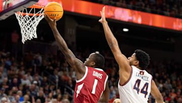Arkansas Razorbacks guard Johnell Davis (1) goes up for a layup over Auburn Tigers center Dylan Cardwell (44) as Auburn Tigers take on Arkansas Razorbacks at Neville Arena in Auburn, Ala., on Wednesday, Feb. 19, 2025.
