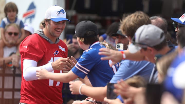 Bills Quarterback Josh Allen gives high-fives to fans as he circles the stadium at the end of Bills training camp at St. John Fisher University in Pittsford, NY on August 8, 2024. Today was the last day at St. John Fisher. Bills Quarterback Josh Allen gives high-fives to fans as he circles the stadium at the end of Bills training camp at St. John Fisher University in Pittsford, NY on August 8, 2024. Today was the last day at St. John Fisher.