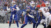 Buffalo Bills QB Josh Allen looks for an open receiver while teammate Spencer Brown looks to block Bengals' Sam Hubbard.