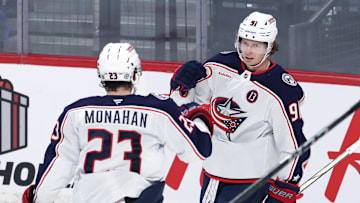 Blue Jackets forwards Sean Monahan and Kent Johnson celebrate a goal. Now full-time linemates, they need some help. 