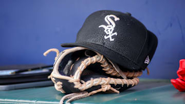 Jul 15, 2023; Atlanta, Georgia, USA; A detailed view of a Chicago White Sox hat and glove in the dugout against the Atlanta Braves in the first inning at Truist Park. Mandatory Credit: Brett Davis-Imagn Images
