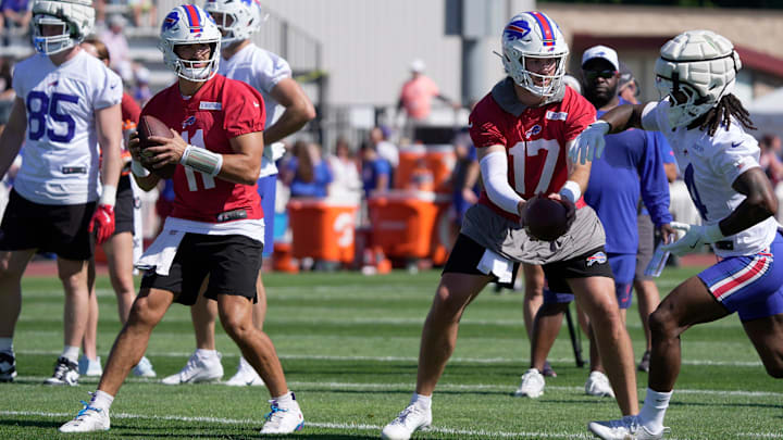 Bills back up quarterback Mitchell Trubisky gets ready to throw a pass while quarterback Josh Allen hands off to running back James Cook during the Buffalo Bills training camp at St. John Fisher University in Pittsford on July 23, 2025.