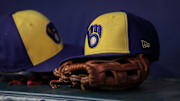 Jul 28, 2023; Atlanta, Georgia, USA; A detailed view of a Milwaukee Brewers hat and glove on the bench against the Atlanta Braves in the second inning at Truist Park. Mandatory Credit: Brett Davis-Imagn Images