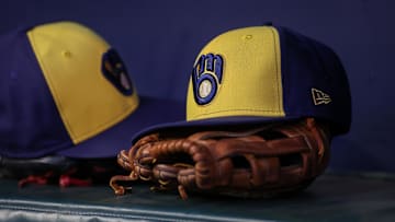 Jul 28, 2023; Atlanta, Georgia, USA; A detailed view of a Milwaukee Brewers hat and glove on the bench against the Atlanta Braves in the second inning at Truist Park. Mandatory Credit: Brett Davis-Imagn Images
