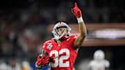 Ohio State Buckeyes running back TreVeyon Henderson (32) scores a touchdown on a 75-yard touchdown catch and run against Texas Longhorns in the second quarter of the Cotton Bowl Classic during the College Football Playoff semifinal game at AT&T Stadium in Arlington, Texas on January, 10, 2025.