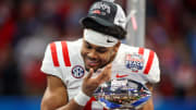 Dec 30, 2023; Atlanta, GA, USA; Mississippi Rebels wide receiver Tre Harris (9) looks into the Peach Bowl trophy after a victory against the Penn State Nittany Lions at Mercedes-Benz Stadium. Mandatory Credit: Brett Davis-USA TODAY Sports
