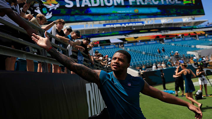 Jacksonville Jaguars cornerback Tyson Campbell (32) greets fans during the ninth day of an NFL football training camp practice Saturday, Aug. 3, 2024 at EverBank Stadium in Jacksonville, Fla. Today marked the first day of public practice inside the stadium.