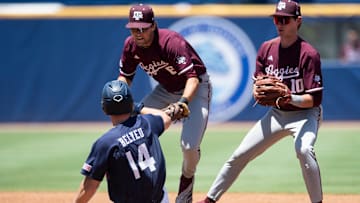 Auburn Tigers' Cade Belyeu (14) is tagged out by Texas A&M Aggies' Kaeden Kent (6) as Auburn Tigers take on Texas A&M Aggies during the SEC baseball tournament at Hoover Met in Birmingham, Ala., on Thursday, May 22, 2025. Texas A&M Aggies defeated Auburn Tigers 3-2.