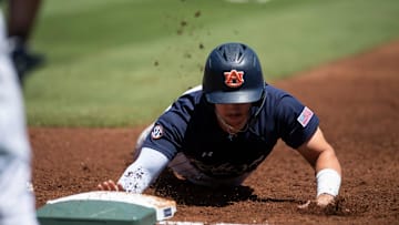 Auburn Tigers' Eric Snow (1) dives safely back into first base as Auburn Tigers take on Texas A&M Aggies during the SEC baseball tournament at Hoover Met in Birmingham, Ala., on Thursday, May 22, 2025.
