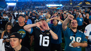Coleman Marley, center, boos expressing his opinion of NFL Commissioner Roger Goodell kicks off the NFL Draft as Adam Watson gives a thumbs down, right, and Chandler Foster, back, looks on during the Duuuval Draft Party Thursday, April 25, 2024 at EverBank Stadium in Jacksonville, Fla. 