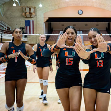 Miami Hurricanes Volleyball teams celebrating after defeating the Indiana Hoosiers. 