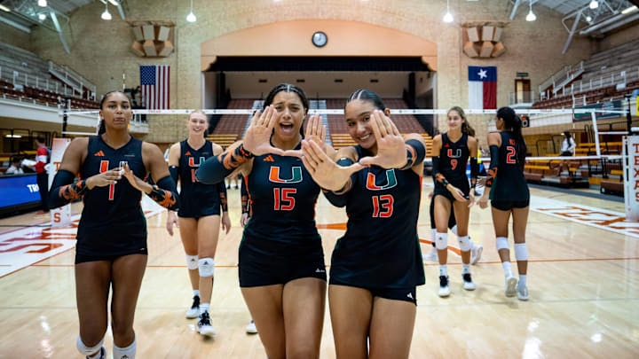 Miami Hurricanes Volleyball teams celebrating after defeating the Indiana Hoosiers. 