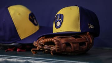 Jul 28, 2023; Atlanta, Georgia, USA; A detailed view of a Milwaukee Brewers hat and glove on the bench against the Atlanta Braves in the second inning at Truist Park. Mandatory Credit: Brett Davis-USA TODAY Sports