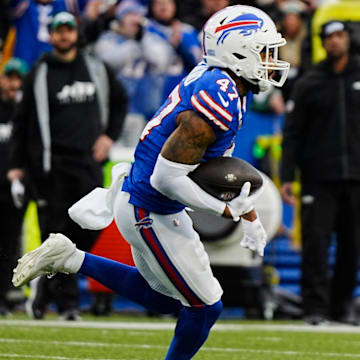 Buffalo Bills cornerback Christian Benford intercepts a pass and runs towards the end zone.