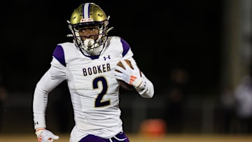 Booker's Tyren Wortham (2) rushes for yards during the first quarter of an FHSAA Class 3A state football semifinal matchup Friday, Dec. 6, 2024 at Raines High School in Jacksonville, Fla.