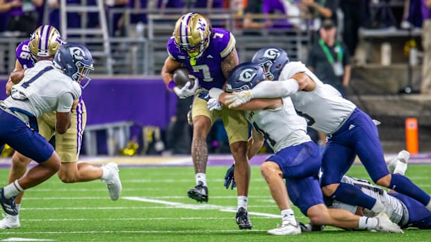 Jonah Coleman takes on a UC Davis tackler. 