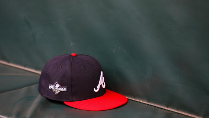 Oct 6, 2023; Atlanta, GA, USA; A detailed view of an Atlanta Braves postseason hat on the bench during a workout before the NLDS against the Philadelphia Phillies at Truist Park. Mandatory Credit: Brett Davis-USA TODAY Sports