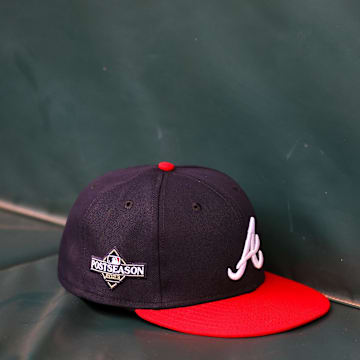 Oct 6, 2023; Atlanta, GA, USA; A detailed view of an Atlanta Braves postseason hat on the bench during a workout before the NLDS against the Philadelphia Phillies at Truist Park. Mandatory Credit: Brett Davis-Imagn Images