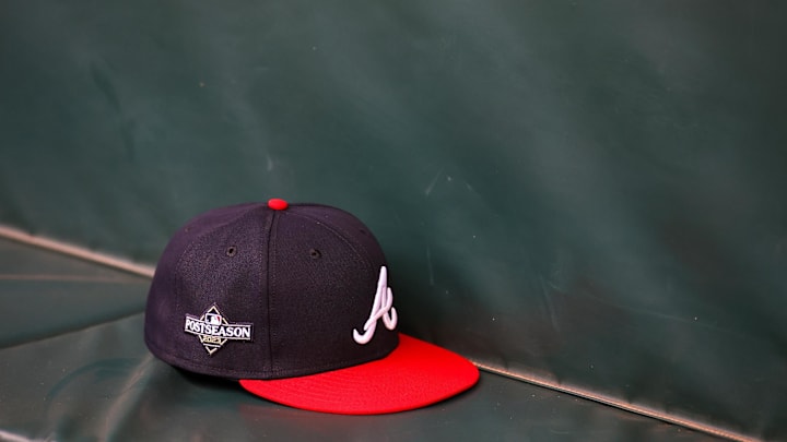 Oct 6, 2023; Atlanta, GA, USA; A detailed view of an Atlanta Braves postseason hat on the bench during a workout before the NLDS against the Philadelphia Phillies at Truist Park. Mandatory Credit: Brett Davis-Imagn Images