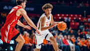 Illinois freshman guard Keaton Wagler (23) drives on an Illinois State defender in the Illini's 92-65 exhibition win over the Redbirds at State Farm Center in Champaign, Illinois.