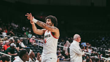Freshman Isaiah Johnson Arigu celebrating a three-pointer on the sideline