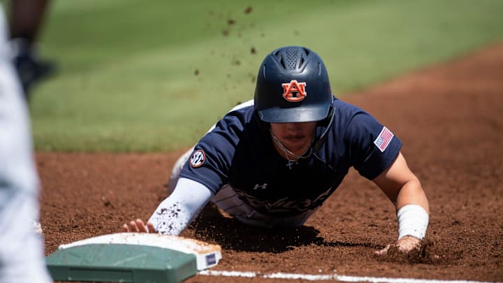 Auburn Tigers' Eric Snow (1) dives safely back into first base as Auburn Tigers take on Texas A&M Aggies during the SEC baseball tournament at Hoover Met in Birmingham, Ala., on Thursday, May 22, 2025.